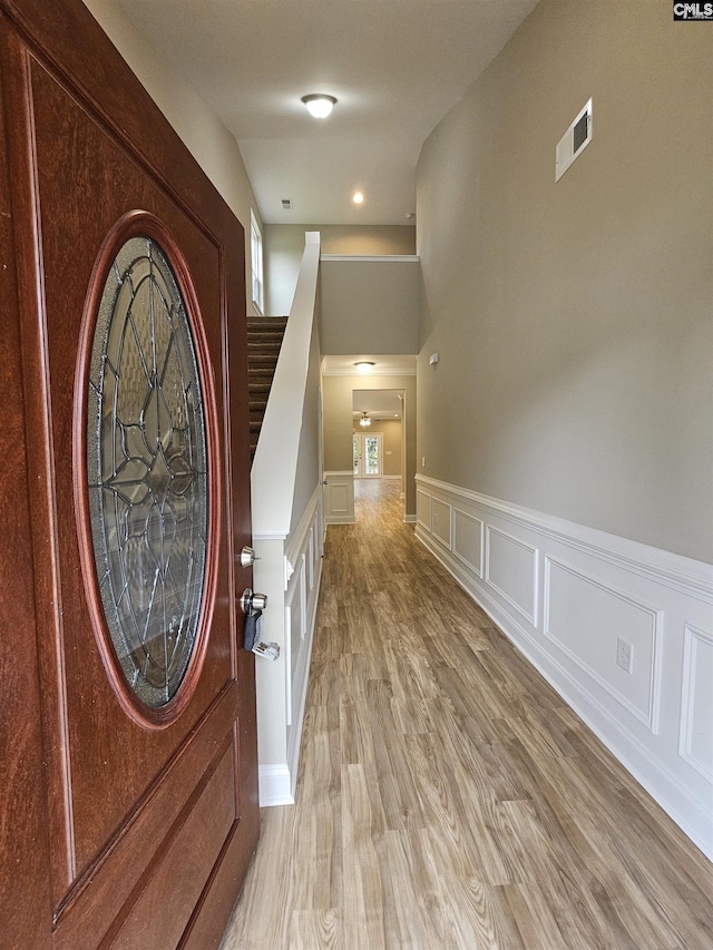 2101 Durham Dr, West Columbia, SC 29170 - foyer entrance with a decorative wall, a wainscoted wall, light wood finished floors, and stairs