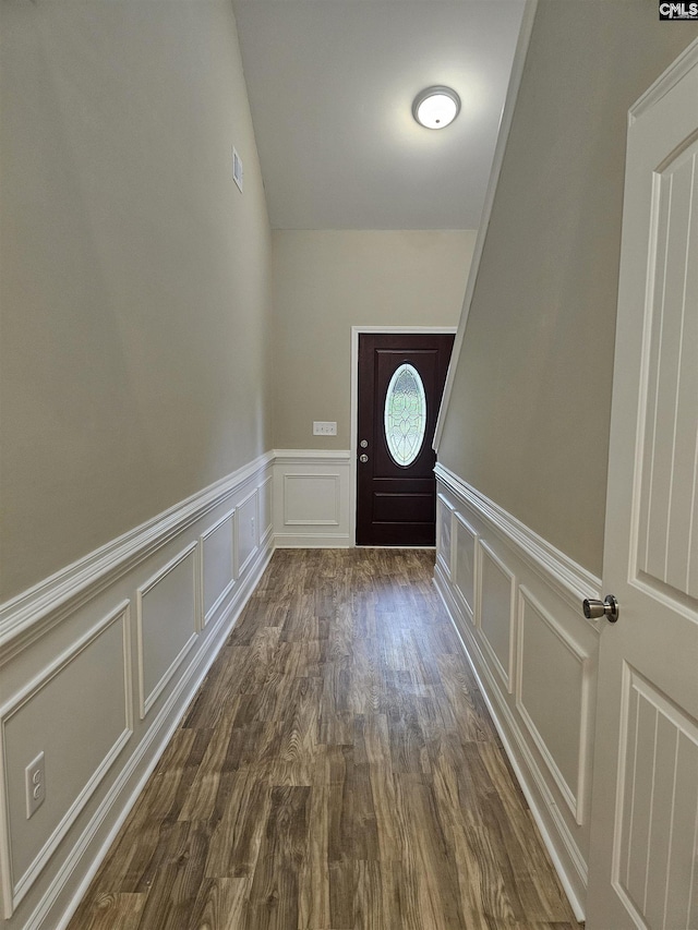 2101 Durham Dr, West Columbia, SC 29170 - doorway to outside with a decorative wall, a wainscoted wall, and dark wood-style flooring