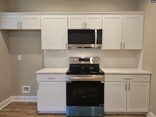2101 Durham Dr, West Columbia, SC 29170 - kitchen featuring stainless steel appliances, backsplash, white cabinets, and dark wood-style floors
