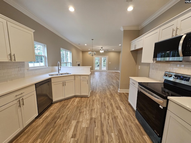 2101 Durham Dr, West Columbia, SC 29170 - kitchen with appliances with stainless steel finishes, a peninsula, light wood-style floors, a ceiling fan, and recessed lighting