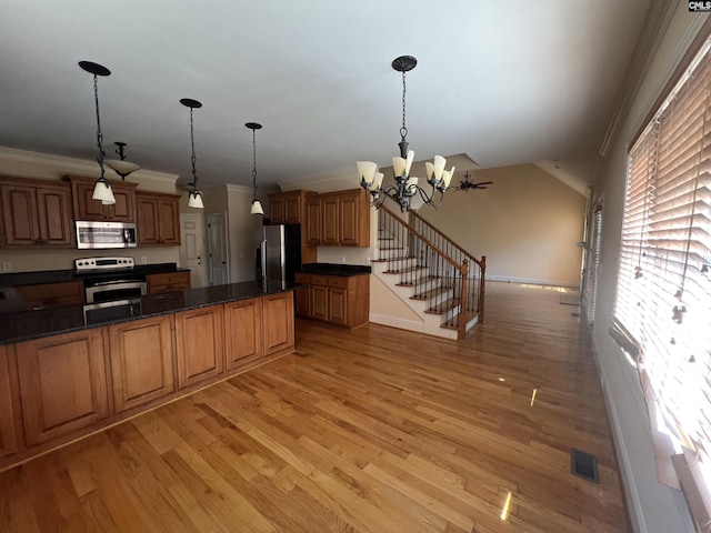218 Scarborough Way, Lexington, SC 29072 - kitchen with appliances with stainless steel finishes, light wood finished floors, ornamental molding, a chandelier, and hanging light fixtures