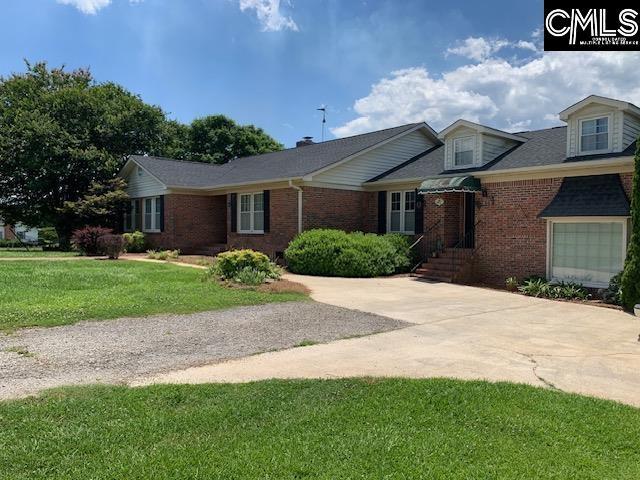 223 Cammack Rd, Winnsboro, SC 29180 - view of front of house with brick siding, driveway, and a front yard
