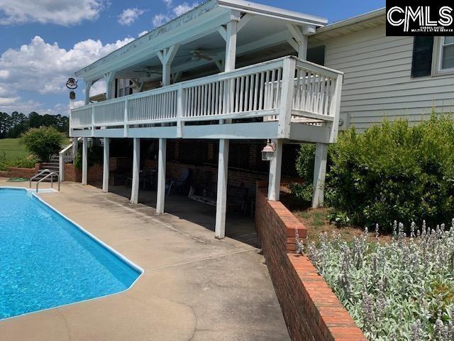 223 Cammack Rd, Winnsboro, SC 29180 - back of house with a patio, an outdoor pool, a ceiling fan, a wooden deck, and stairs