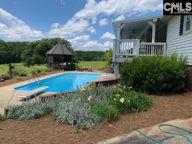 223 Cammack Rd, Winnsboro, SC 29180 - outdoor pool featuring a gazebo, a ceiling fan, and a diving board