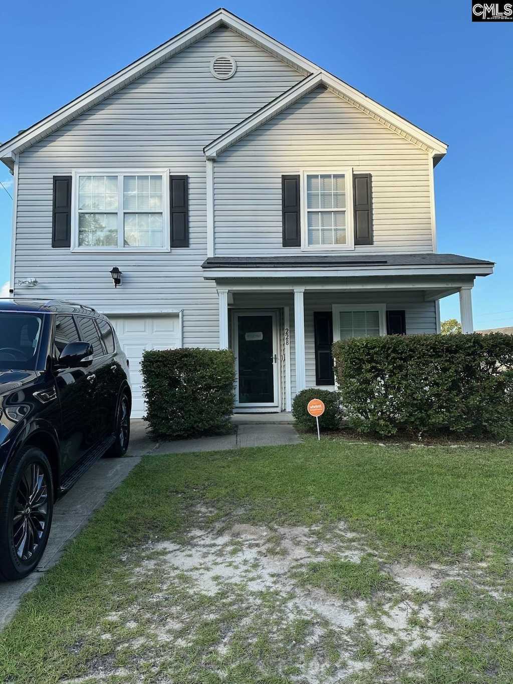 228 Arbor Falls Dr, Columbia, SC 29229 - view of front of property with an attached garage, a front lawn, driveway, and covered porch
