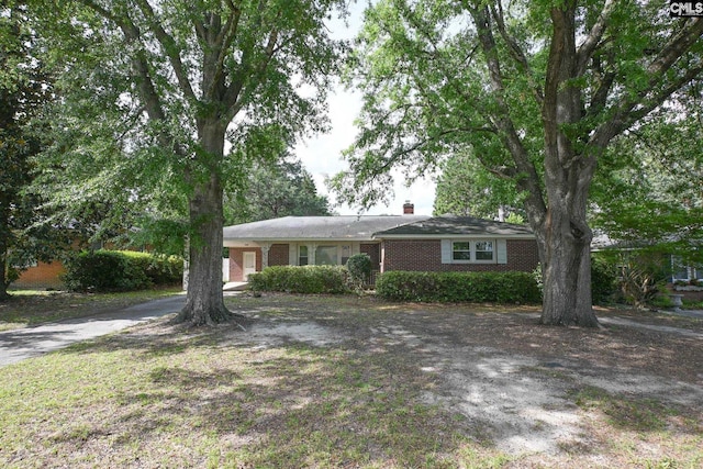 1120 Garden Ave, Cayce, SC 29033 - single story home with brick siding, concrete driveway, a chimney, and an attached carport