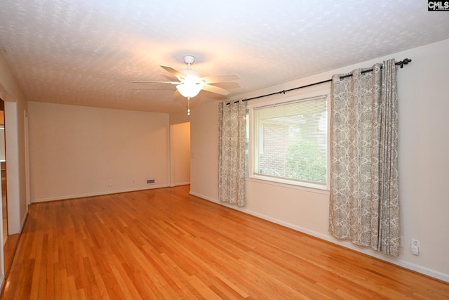 1120 Garden Ave, Cayce, SC 29033 - empty room with light wood-style flooring, a ceiling fan, and a textured ceiling