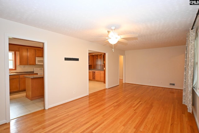 1120 Garden Ave, Cayce, SC 29033 - spare room with ceiling fan, light wood-style flooring, and a textured ceiling