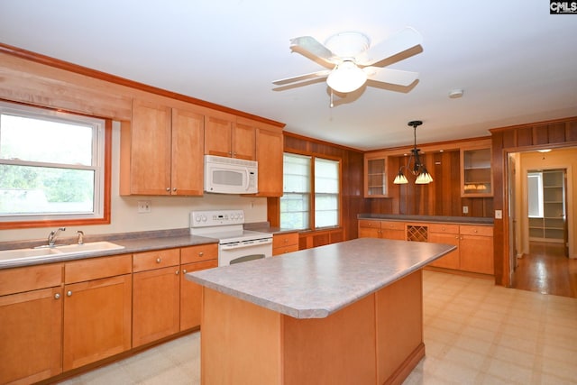 1120 Garden Ave, Cayce, SC 29033 - kitchen featuring white appliances, light floors, a center island, glass insert cabinets, and hanging light fixtures