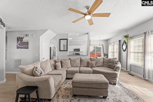 218 Founders Ridge Rd, Columbia, SC 29229 - living room with ceiling fan, light wood finished floors, and a textured ceiling