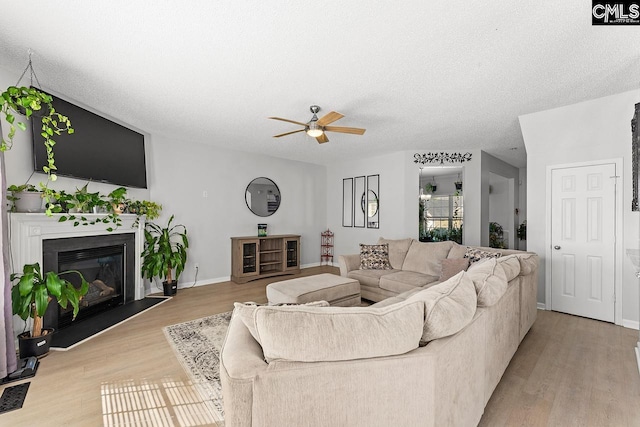 218 Founders Ridge Rd, Columbia, SC 29229 - living area with a ceiling fan, light wood-type flooring, a glass covered fireplace, and a textured ceiling