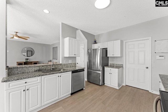 218 Founders Ridge Rd, Columbia, SC 29229 - kitchen with appliances with stainless steel finishes, a textured ceiling, light wood finished floors, white cabinetry, and a ceiling fan