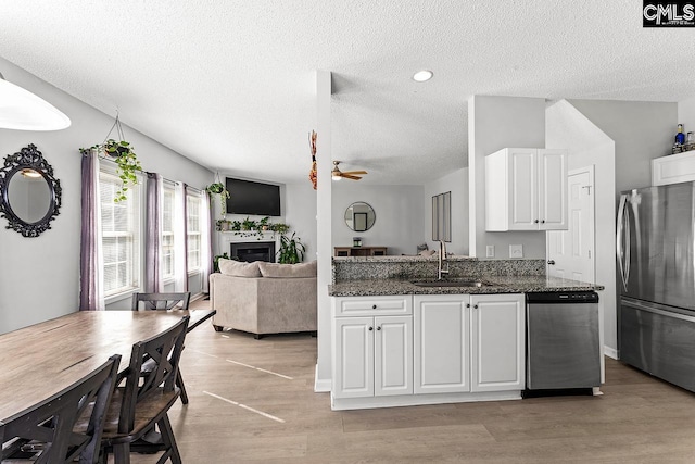 218 Founders Ridge Rd, Columbia, SC 29229 - kitchen with appliances with stainless steel finishes, a textured ceiling, white cabinets, ceiling fan, and light wood-style floors