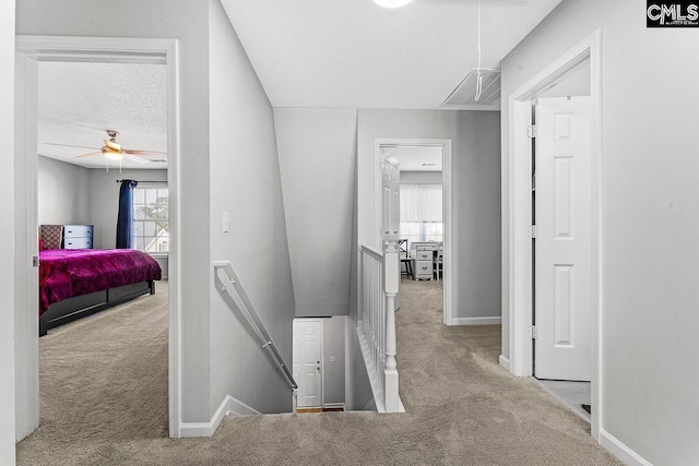 218 Founders Ridge Rd, Columbia, SC 29229 - hallway featuring attic access, an upstairs landing, carpet floors, and a textured ceiling