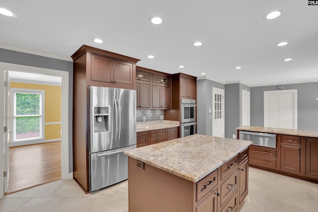 2432 Bermuda Hills Rd, Columbia, SC 29223 - kitchen featuring stainless steel appliances, a warming drawer, ornamental molding, a kitchen island, and light stone countertops