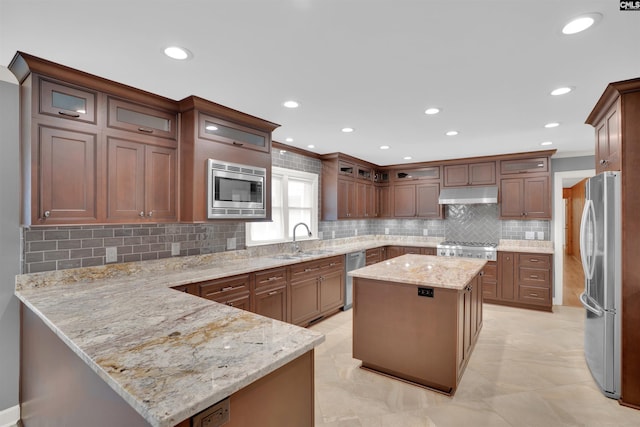2432 Bermuda Hills Rd, Columbia, SC 29223 - kitchen featuring under cabinet range hood, stainless steel appliances, a peninsula, backsplash, and light stone counters