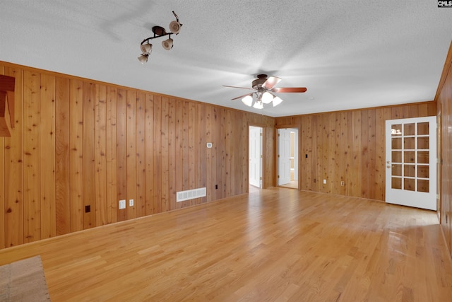 2432 Bermuda Hills Rd, Columbia, SC 29223 - unfurnished room featuring a ceiling fan, wood walls, a textured ceiling, and wood finished floors