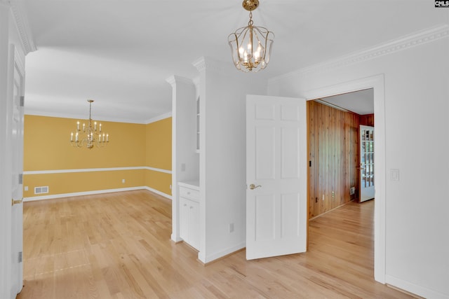 2432 Bermuda Hills Rd, Columbia, SC 29223 - spare room with a chandelier, light wood finished floors, crown molding, and wooden walls