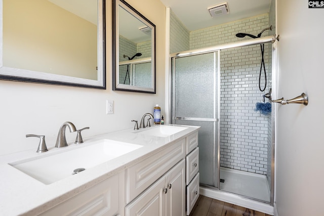 289 King Charles Rd, Columbia, SC 29209 - bathroom featuring a shower stall, double vanity, and wood finished floors