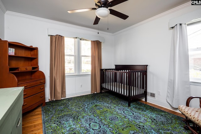289 King Charles Rd, Columbia, SC 29209 - bedroom featuring wood finished floors, crown molding, a crib, and ceiling fan