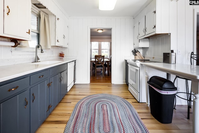 289 King Charles Rd, Columbia, SC 29209 - kitchen featuring white appliances, blue cabinetry, light wood-type flooring, light countertops, and white cabinets