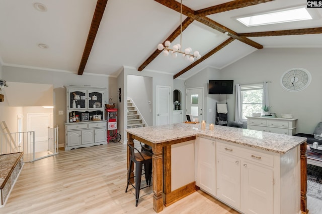 330 Grantham Rd, Irmo, SC 29063 - kitchen with open floor plan, light wood-type flooring, white cabinets, and light stone counters