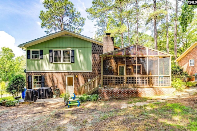 330 Grantham Rd, Irmo, SC 29063 - back of property featuring a chimney, a sunroom, brick siding, and board and batten siding