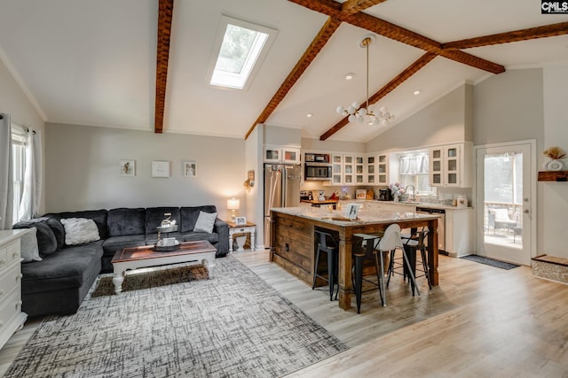 330 Grantham Rd, Irmo, SC 29063 - living room with a skylight, beam ceiling, light wood-style flooring, healthy amount of natural light, and high vaulted ceiling