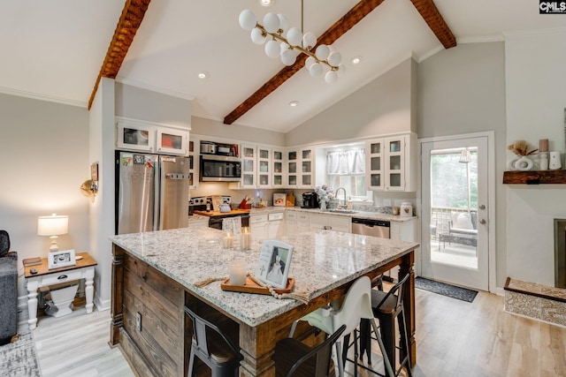 330 Grantham Rd, Irmo, SC 29063 - kitchen with appliances with stainless steel finishes, light wood-type flooring, a center island, white cabinets, and glass insert cabinets