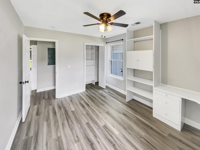 1524 Highway Church Rd, Elgin, SC 29045 - unfurnished bedroom featuring wood finished floors, electric panel, a closet, ceiling fan, and multiple windows