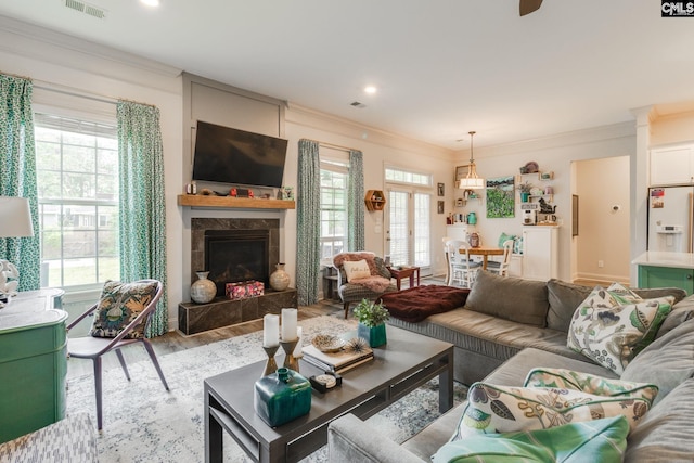 6150 Crabtree Rd, Columbia, SC 29206 - living area with ornamental molding, wood finished floors, a tile fireplace, a ceiling fan, and recessed lighting