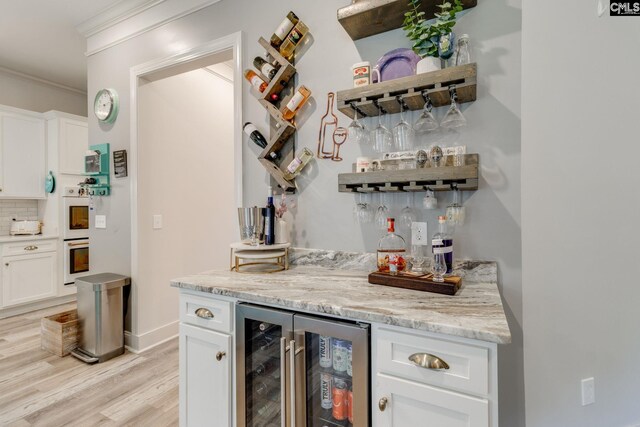6150 Crabtree Rd, Columbia, SC 29206 - indoor dry bar with beverage cooler, light wood-type flooring, decorative backsplash, ornamental molding, and double oven