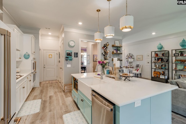 6150 Crabtree Rd, Columbia, SC 29206 - kitchen with stainless steel appliances, open floor plan, white cabinetry, crown molding, and light wood-style flooring