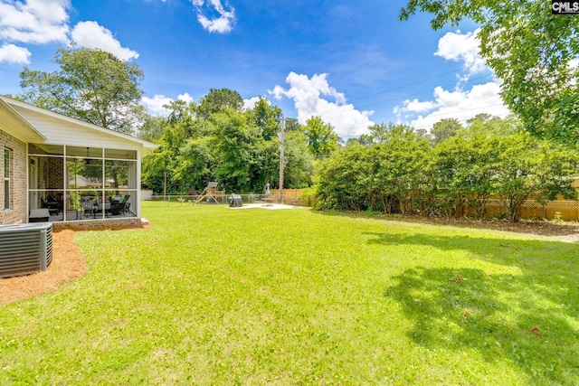 6150 Crabtree Rd, Columbia, SC 29206 - fenced backyard with a playground, a sunroom, and view of scattered trees