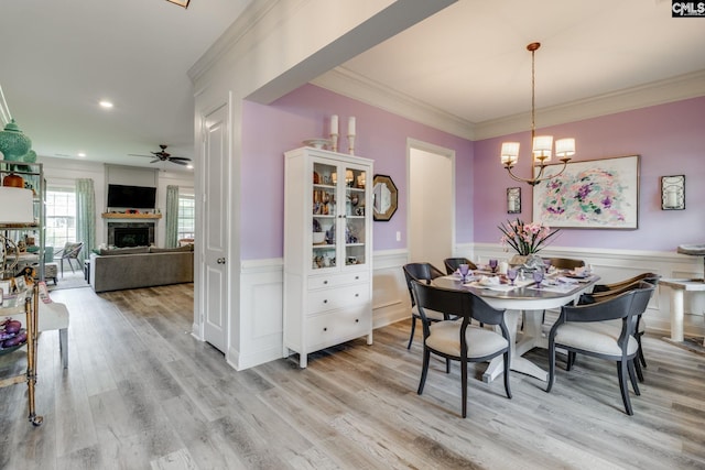 6150 Crabtree Rd, Columbia, SC 29206 - dining area featuring a fireplace, a wainscoted wall, crown molding, a chandelier, and light wood finished floors