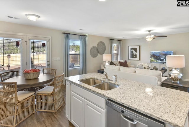 15 Ozark Dr, Columbia, SC 29223 - kitchen with stainless steel dishwasher, a ceiling fan, wood finished floors, a kitchen island with sink, and light stone counters