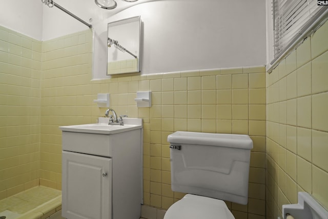227 Latonea Dr, Columbia, SC 29210 - bathroom featuring tiled shower, tile walls, vanity, and a wainscoted wall