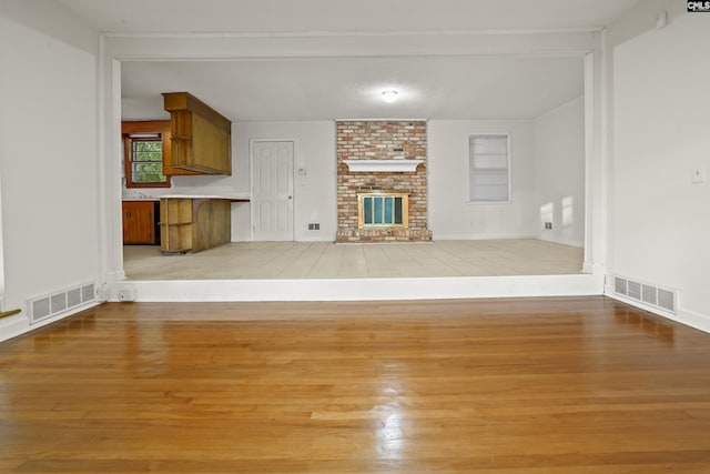 227 Latonea Dr, Columbia, SC 29210 - unfurnished living room with light wood-style floors and a fireplace