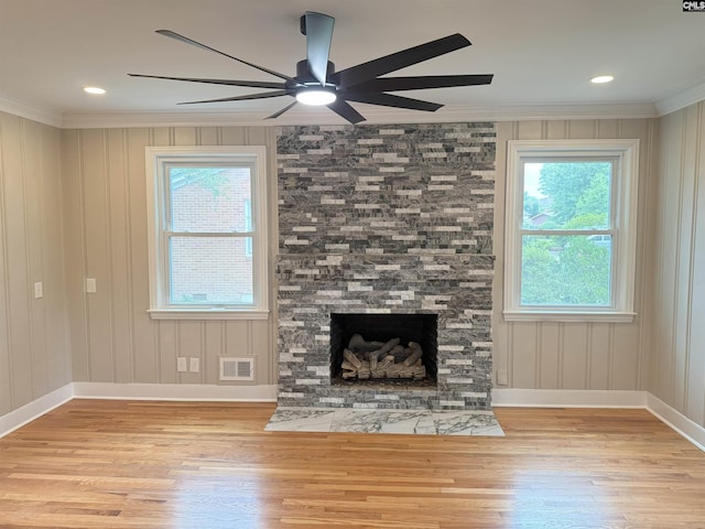 1341 Sanford Rd, Columbia, SC 29206 - unfurnished living room with ornamental molding, plenty of natural light, wood finished floors, a ceiling fan, and a fireplace