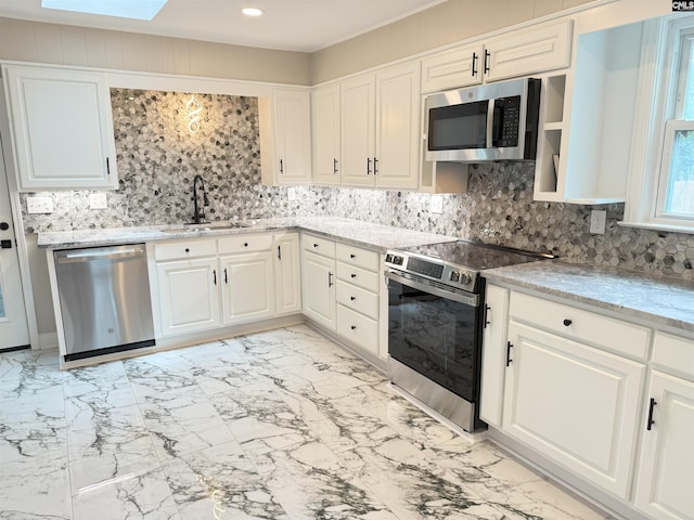 1341 Sanford Rd, Columbia, SC 29206 - kitchen with stainless steel appliances, light marble finish flooring, tasteful backsplash, white cabinetry, and recessed lighting