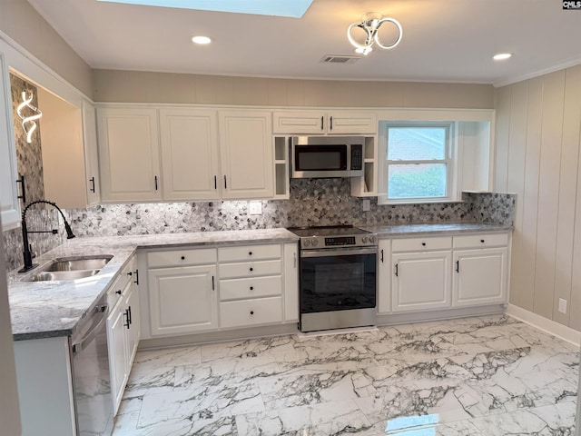 1341 Sanford Rd, Columbia, SC 29206 - kitchen featuring appliances with stainless steel finishes, decorative backsplash, white cabinets, light stone counters, and recessed lighting