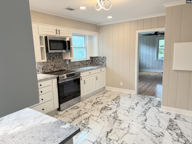 1341 Sanford Rd, Columbia, SC 29206 - kitchen featuring stainless steel appliances, crown molding, plenty of natural light, white cabinets, and recessed lighting
