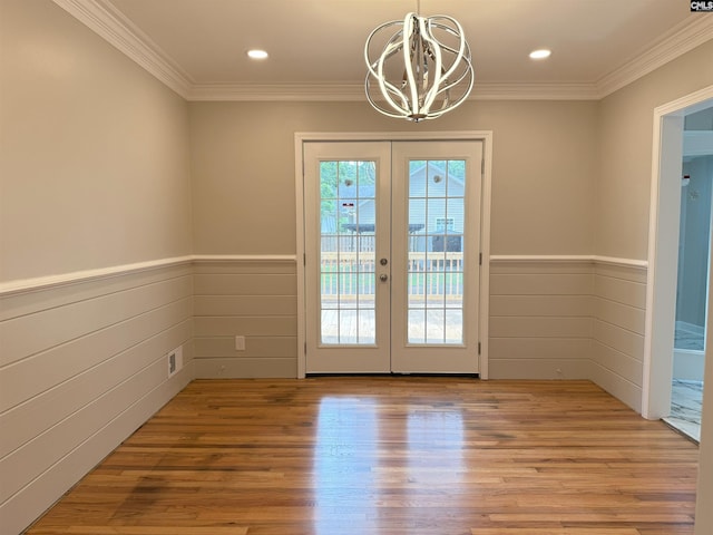 1341 Sanford Rd, Columbia, SC 29206 - doorway to outside featuring french doors, a chandelier, crown molding, wainscoting, and wood finished floors