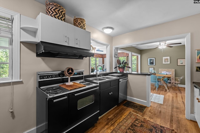 110 Summerlea Dr, Columbia, SC 29203 - kitchen featuring black electric range oven, exhaust hood, stainless steel dishwasher, and dark wood-style flooring