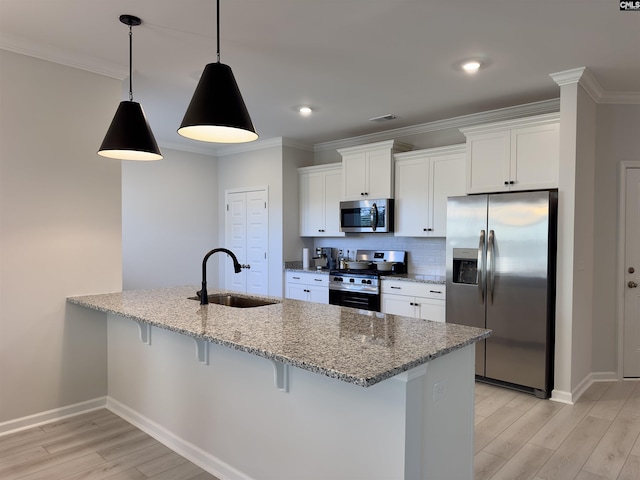 15 Runelle Ln, Columbia, SC 29229 - kitchen featuring stainless steel appliances, light wood-style floors, a breakfast bar, white cabinets, and ornamental molding