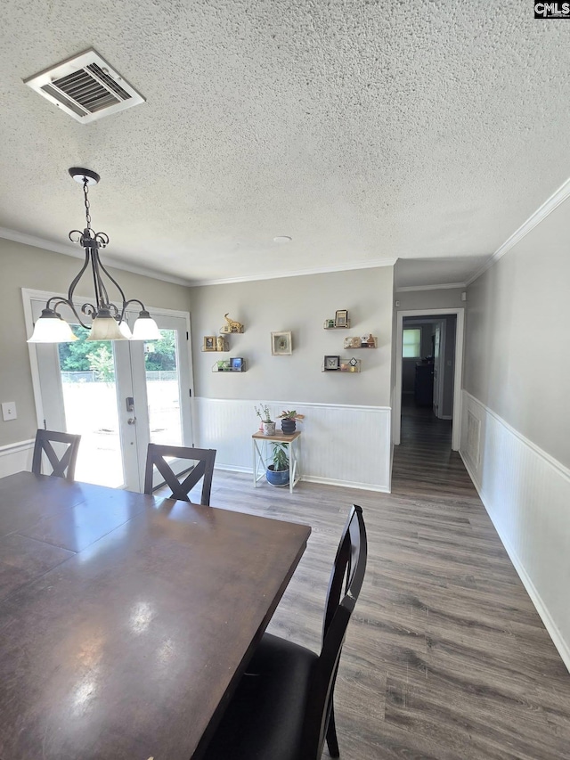 704 Cambridge, Lugoff, SC 29078 - dining space featuring french doors, a textured ceiling, crown molding, a wainscoted wall, and wood finished floors