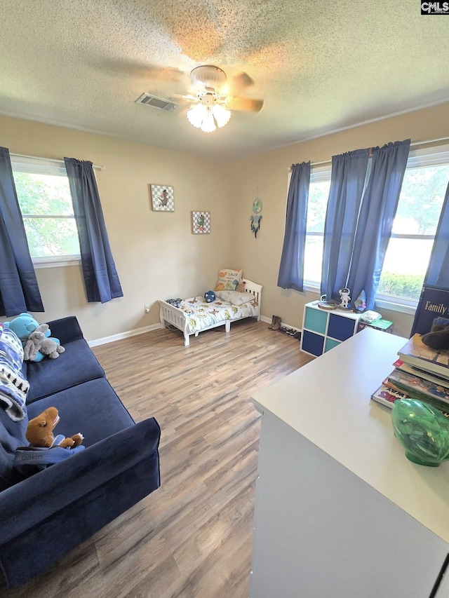 704 Cambridge, Lugoff, SC 29078 - bedroom with multiple windows, wood finished floors, a textured ceiling, and ceiling fan