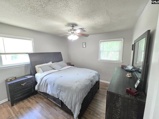 704 Cambridge, Lugoff, SC 29078 - bedroom featuring a textured ceiling, wood finished floors, and a ceiling fan