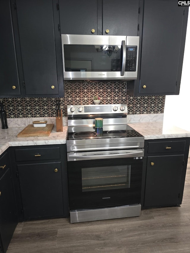 704 Cambridge, Lugoff, SC 29078 - kitchen featuring stainless steel appliances, decorative backsplash, and dark wood-style floors
