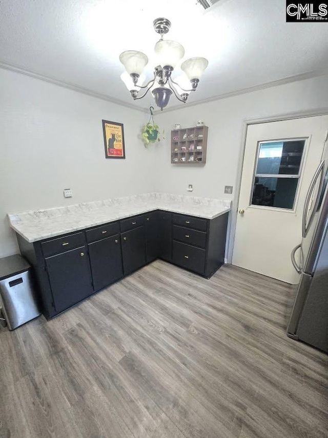 704 Cambridge, Lugoff, SC 29078 - unfurnished dining area with a chandelier, light wood-style floors, and crown molding